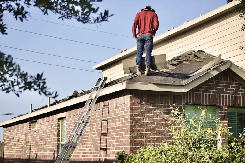 Professional roofer working on a residential roof in Biddeford